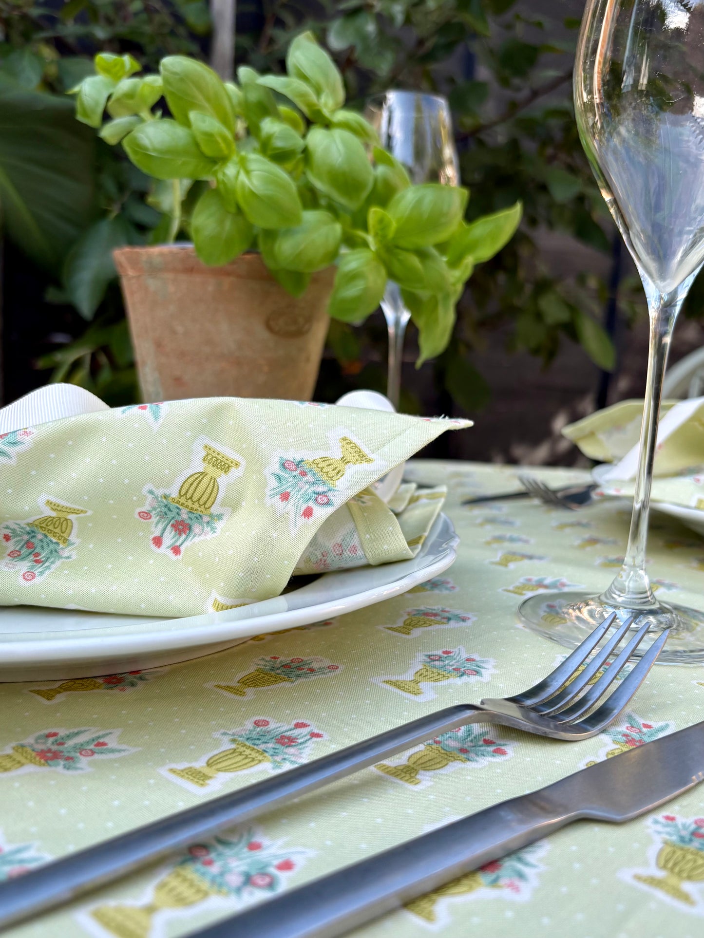 Green garden party tablecloth and matching set of 4 napkins made from Liberty cotton fabric, featuring a floral print ideal for outdoor gatherings or elegant dining.