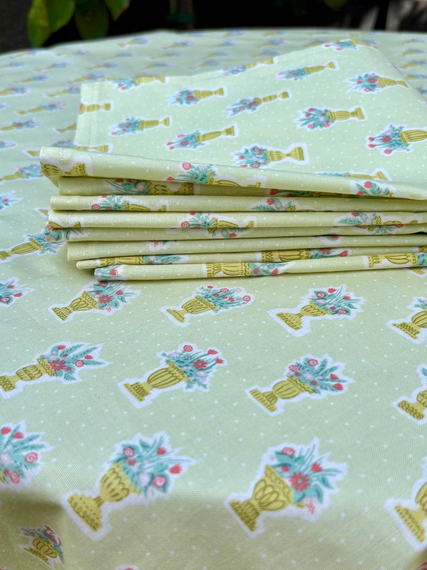 Green garden party tablecloth and matching set of 4 napkins made from Liberty cotton fabric, featuring a floral print ideal for outdoor gatherings or elegant dining.