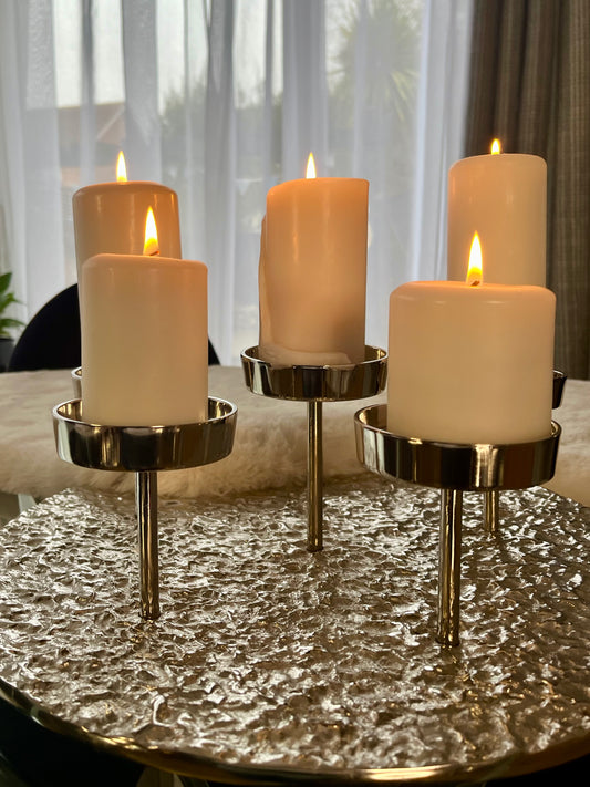 Silver aluminium Luna candle holder with six varying-height candle stands on a round base, creating a modern and stylish design